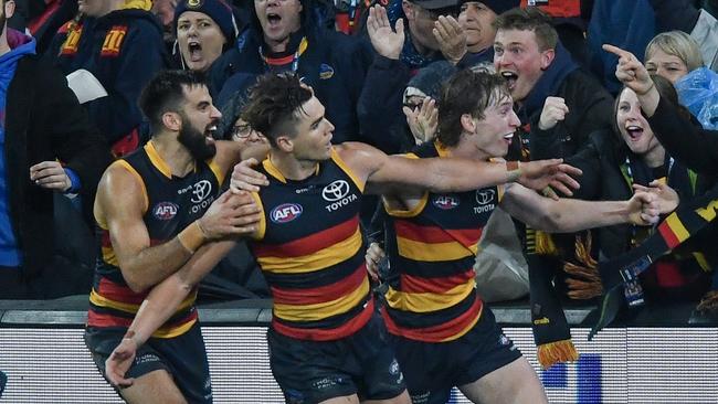 ADELAIDE, AUSTRALIA - AUGUST 19:Ben Keays of the Crows celebrates a goal in the last quarter with Wayne Milera and Max Michalanney  only to be called a poinduring the round 23 AFL match between Adelaide Crows and Sydney Swans at Adelaide Oval, on August 19, 2023, in Adelaide, Australia. (Photo by Mark Brake/Getty Images)