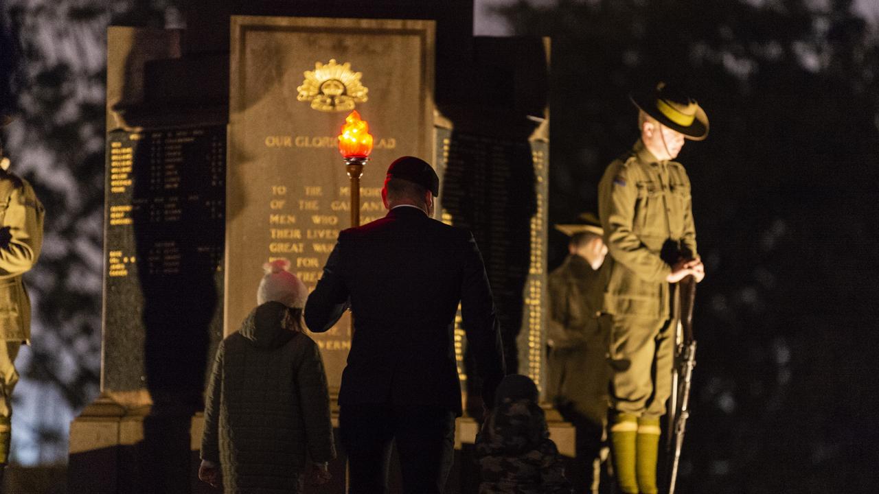 Torch bearer Josh Hawkins takes the torch to the Mothers Memorial at the Anzac Day dawn service, Monday, April 25, 2022. Picture: Kevin Farmer