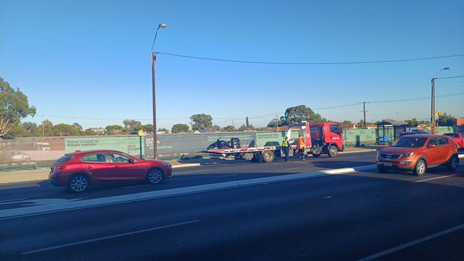 A tow truck removes a motorcycle from the scene of a crash on South Rd at Clovelly Park. Picture: Aden Hill