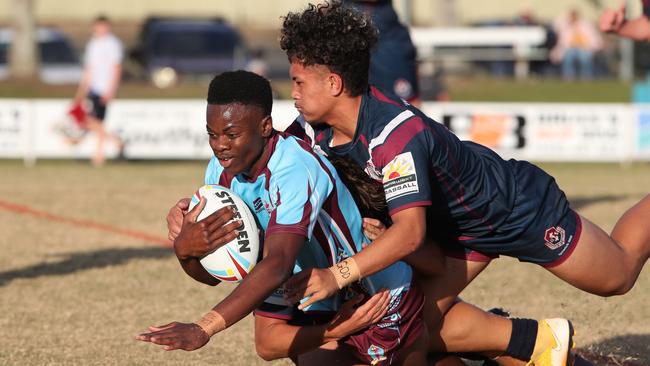 Ipswichs Junior Moliga tackles Keebras Mungu Barawini. Picture Glenn Hampson