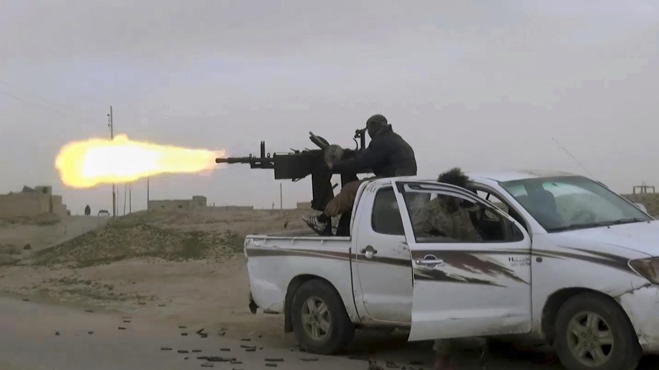 A gun-mounted Islamic State group vehicle firing at members of the US-backed Syrian Democratic Forces. Picture: Militant Photo via AP