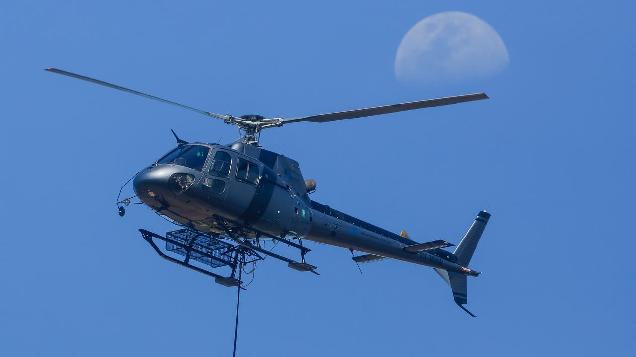 Water bombers battle dangerous fire conditions as a bushfire rolls through the Litchfield/Batchelor area in late August. Picture: Glenn Campbell