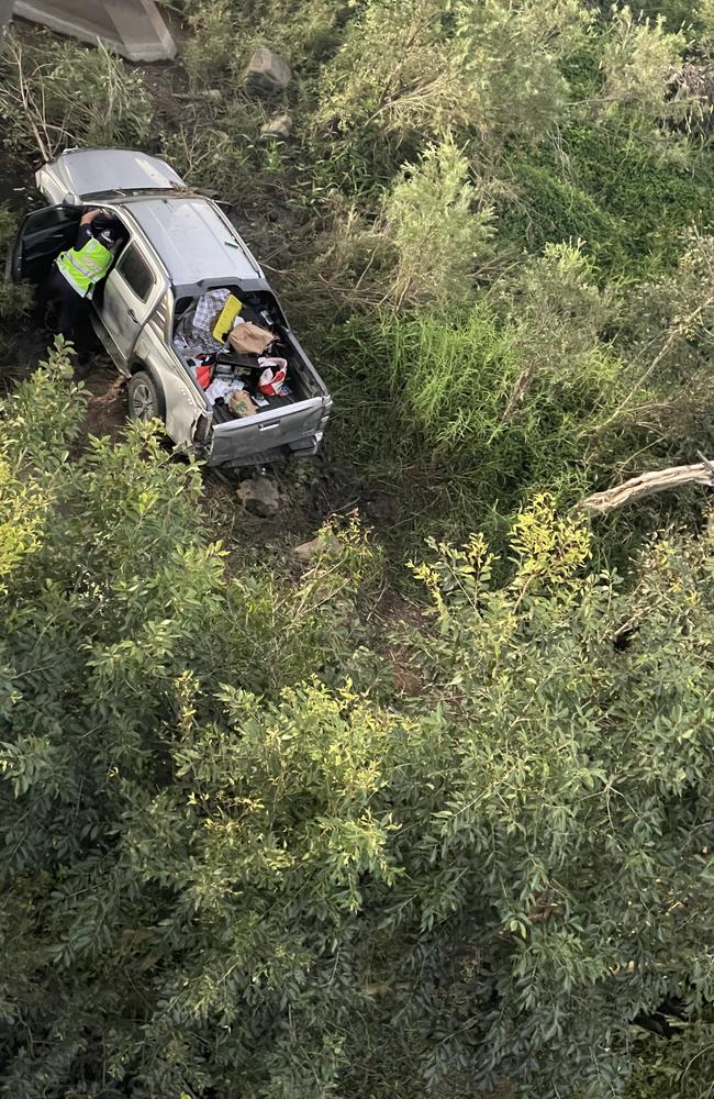 Emergency crews rushed to the George L Vickers bridge at Marian after a ute carrying three women and three dogs left the road and crashed down a 10m embankment and into mangroves. Picture: Janessa Ekert