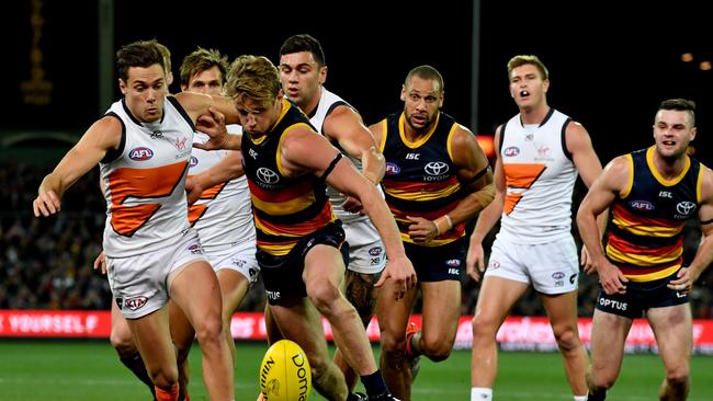 Sloane leads Giants star Josh Kelly in the race to the loose footy. Picture: AAP Image/Sam Wundke