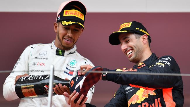 Lewis Hamilton pours Daniel Ricciardo a shoey.