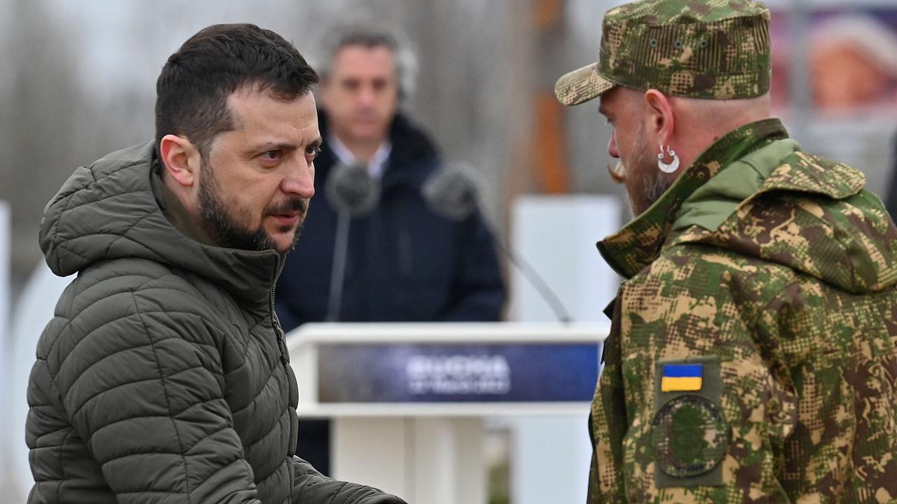 Mr Zelensky shaking hands with a Ukrainian soldier in Bucha. Picture: Sergei Supinsky/AFP