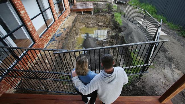 Dana Lunn and her husband Rohan with the hole in their garden The couple have spent $40k on a pool that wasn’t delivered, and they’re not alone. Picture: Alan Barber