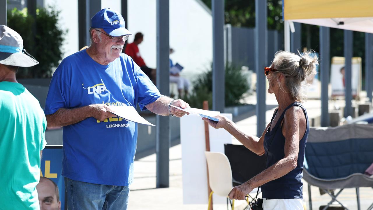 Retiring Member for Leichhardt Warren Entsch hands out how to vote cards for the federal election at the Australian Electoral Commission pre polling centre, set up at the Tjapukai Cultural Park in Smithfield, Cairns. Picture: Brendan Radke