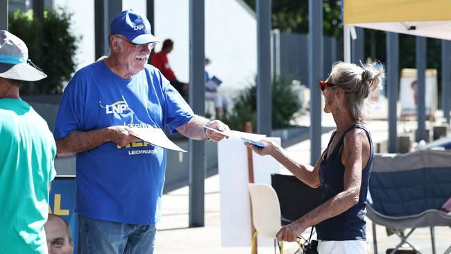Retiring Member for Leichhardt Warren Entsch hands out how to vote cards for the federal election at the Australian Electoral Commission pre polling centre, set up at the Tjapukai Cultural Park in Smithfield, Cairns. Picture: Brendan Radke