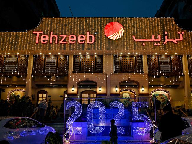 A man walks past an illuminated decoration displayed on New Year's Eve in Islamabad on December 31, 2024. Picture: AFP