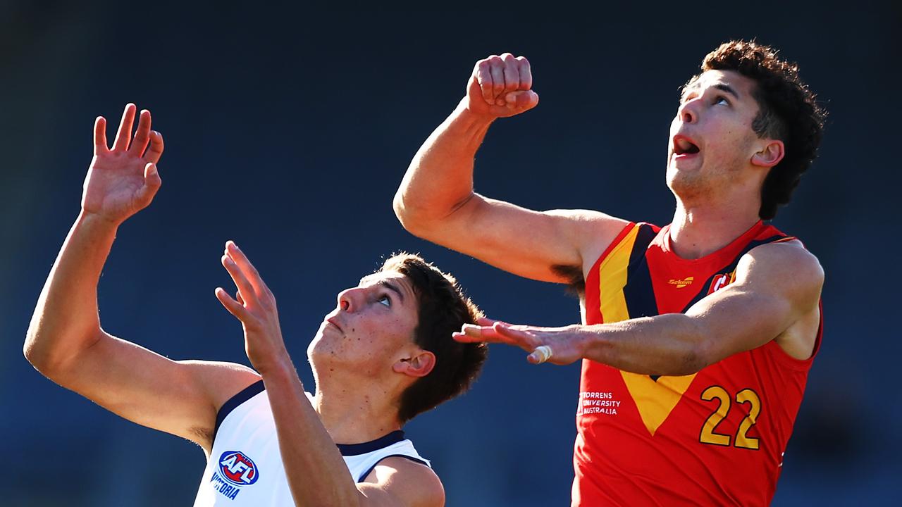 William McCabe (right) prepares to make a big spoil. Picture: Graham Denholm/AFL Photos via Getty Images