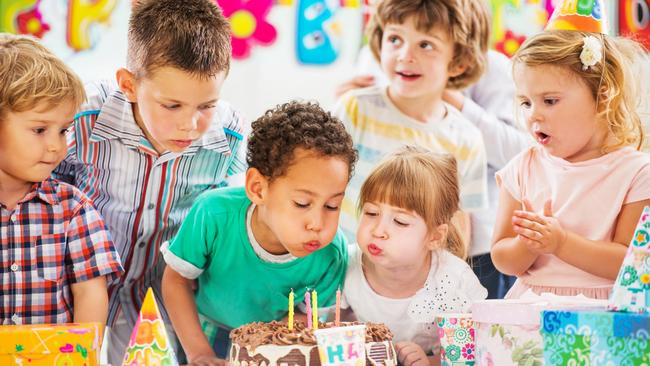 Children blowing birthday candles.