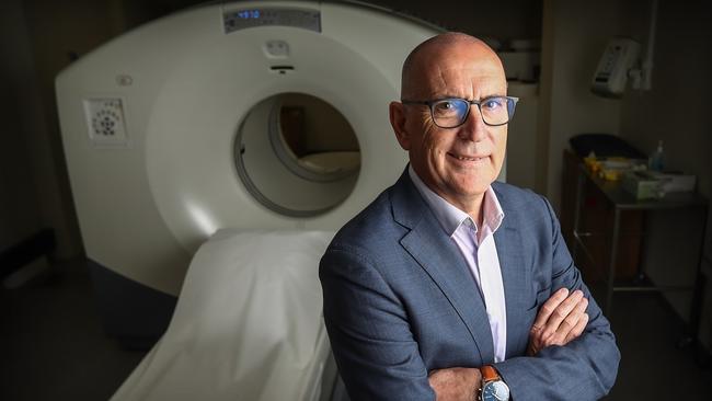 Associate Professor Peter O'Brien, chief medical officer at GenesisCare, with a PET scanner at Waratah Private Hospital in Hurstville. Picture: Hollie Adams