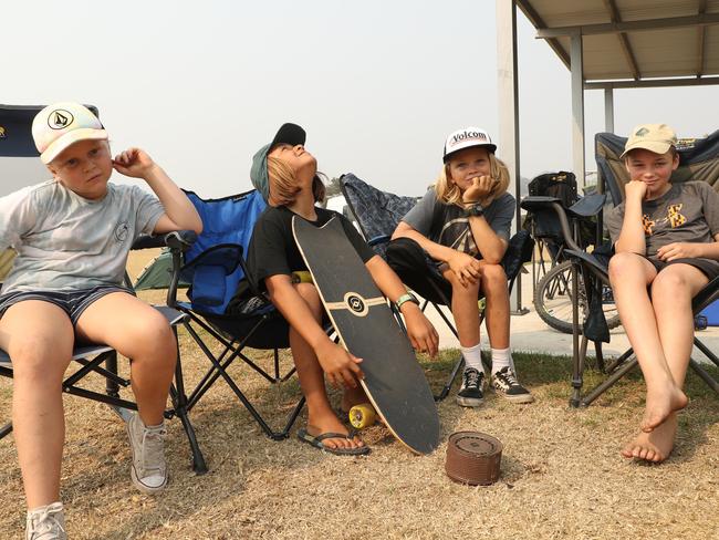 Parker Whiteman, Jet Love, Miller Whiteman and Naite Whiteman and their families evacuated to Malua Bay beach for safety. Picture: John Grainger