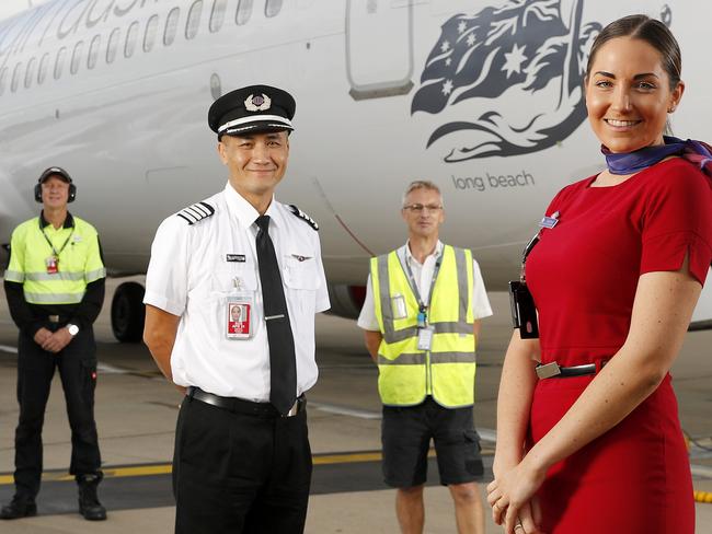 Virgin staff Phil Vlieg, Captain Anthony Saville, Peter Armstrong and Alahna Wilkinson posing in front of Long Beach, 737-800 at the Brisbane Domestic Airport, Brisbane 14th of May 2020.