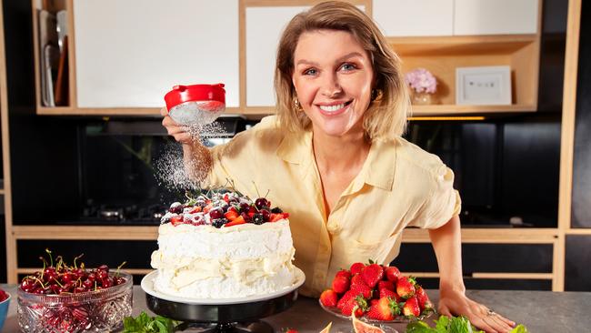 Coles ambassador Courtney Roulston makes a pavlova using Remedy kombucha. Proceeds from the sales of the special festive-flavoured drinks will go towards supporting SecondBite’s efforts to address food security in Australia. Picture Rebecca Michael