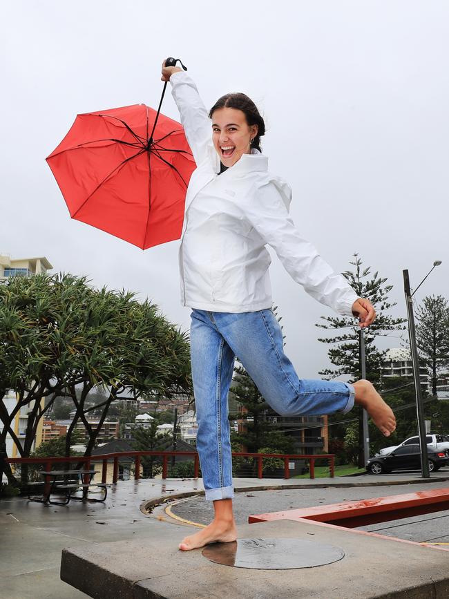 Palm Beach Currumbin student Amy Van den Akker fights the strong wind and rain as the Gold Coast is inundated with heavy rainfall and flooding. NCA NewsWire / Scott Powick