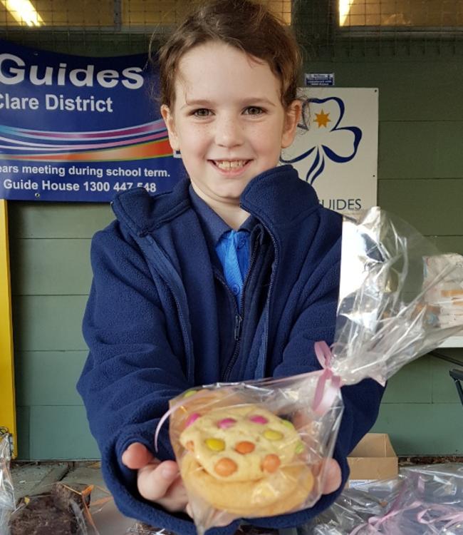 Point Clare Junior Guide Lily Walsh selling biccies on election day.