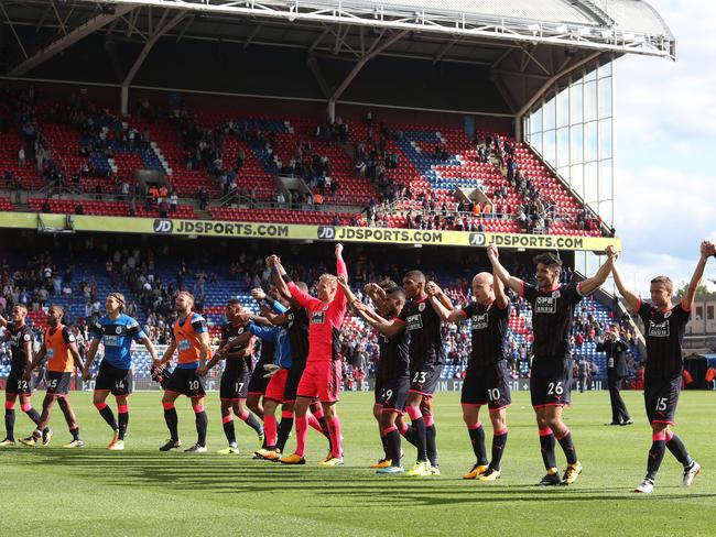 Huddersield Town celebrate their 100 per cent winning record in the Premier League.