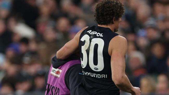 Charlie Curnow is helped from the MCG after rolling his ankle last weekend. Picture: Daniel Pockett/Getty Images