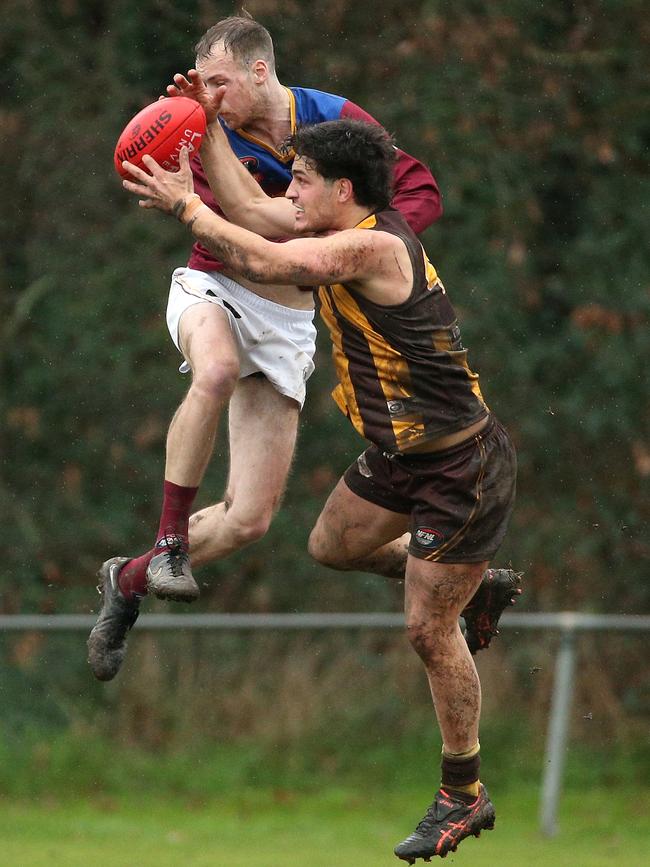 NFL: Heidelberg West’s Ayman O'Dowd holds the mark under pressure from Ben Peterson of South Morang. Picture: Hamish Blair