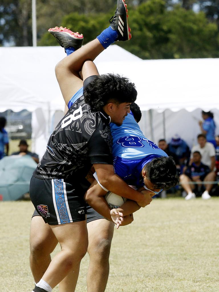 Loonidus Farr tackles from Maori Pango tackles Kingston Taliu from Samoa white. Under 16 Boys Maori Pango v Samoa white. Harmony Nines Rugby League. Picture: John Appleyard