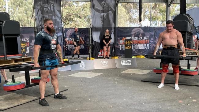 Competitors lifting 300kg barbecues as part of Strong Man competition at Meatstock 2023 at the Melbourne Showgrounds.