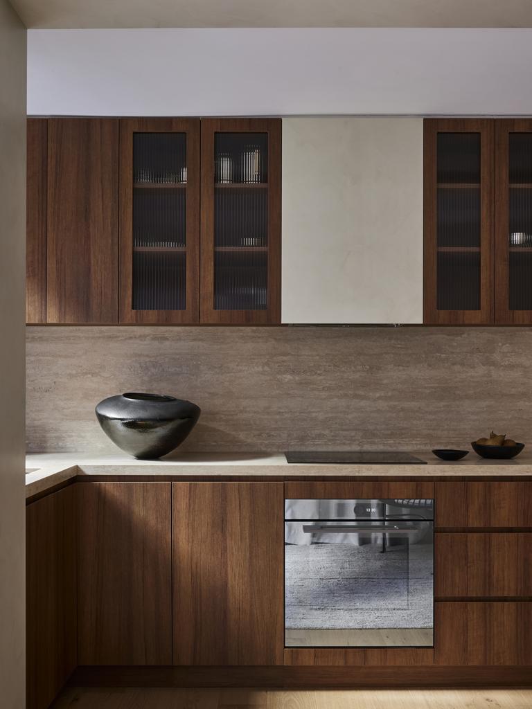 The kitchen features a stone benchtop, beautiful joinery and V-Zug appliances.