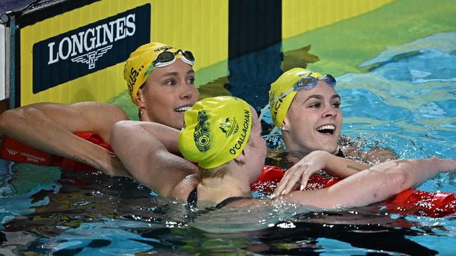 Silver medallist Australia's Shayna Jack (R) and Bronze medallist Australia's Emma McKeon (L) congratulate winner and gold medallist Australia's Mollie O'Callaghan