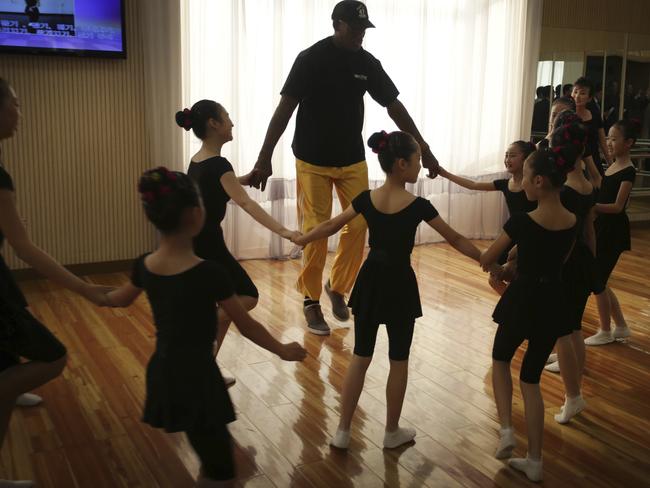 Dennis Rodman dances with schoolchildren at the Mangyongdae School Children's Palace. Picture: AP Photo/Kim Kwang Hyon