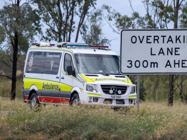 Ambulance leaves the scene of fatal crash involving car and truck on Warrego Highway between Bowenville and Dalby. Sunday, January 30, 2022. Picture: Nev Madsen.