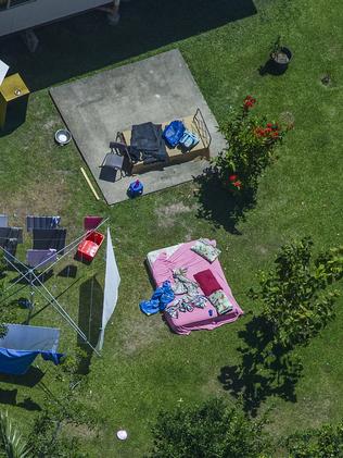 A mattress and clothing are strewn across the backyard of the house. Picture: Brian Cassey