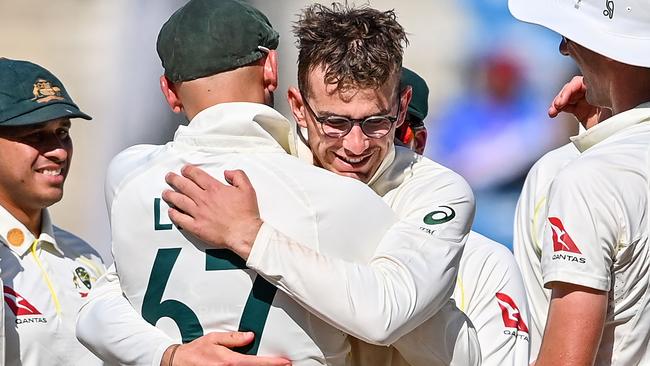 Australia's players get round Todd Murphy after he took the wicket of India's Srikar Bharat – his fifth of the day. Picture: AFP.