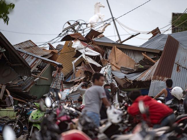 Residents look for their belongings amid the debris of destroyed houses in Palu in Central Sulawesi. Picture: AFP