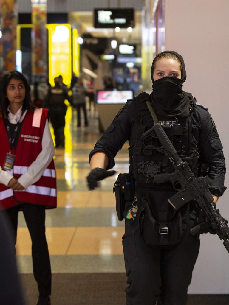 A security guard and armed police woman outside the centre during the lockdown. Picture: Brett Hartwig