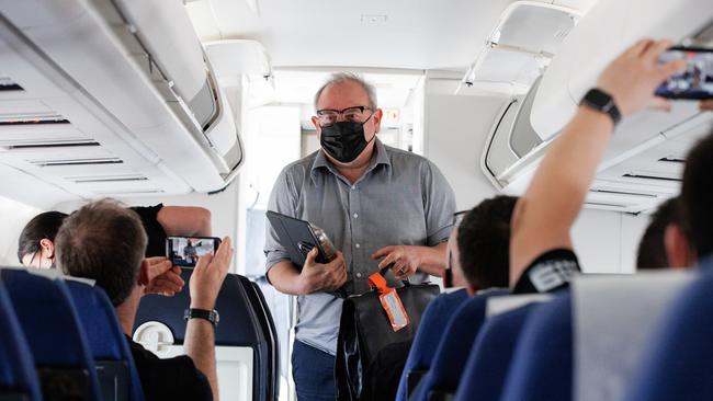 The PMO and the Prime Minister Scott Morrison board the media plane after a water leak grounded BBJ. Picture: Jason Edwards