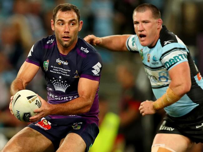 Storm's Cameron Smith looks to offload in front of Shark's Paul Gallen during the 2016 NRL Grand Final between the Cronulla Sharks and the Melbourne Storm at ANZ Stadium , Homebush . Picture : Gregg Porteous