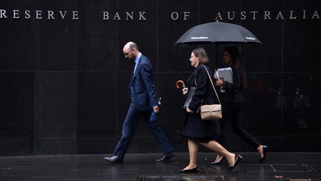 Pedestrians walks past the Reserve Bank of Australia. Picture: AFP