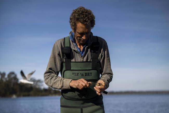 Second generation oyster farmer Dom Boyton shucks an oyster freshly picked from his pots in Merimbula Lake, NSW. Picture by Sean Davey.