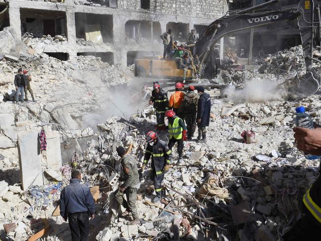 Algerian rescue teams (red helmets) take part in the search and rescue operations in Syria's northern city of Aleppo. Picture: AFP