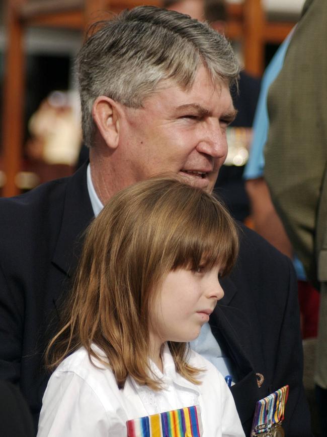 Mayor Kevin Byrne with daughter Isabel, 6, at the Cairns Anzac Day Wreath Laying service in 2004. Picture: Pasco Rogato