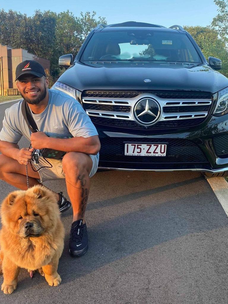 Payne Haas and his dog pose in front of his new car.