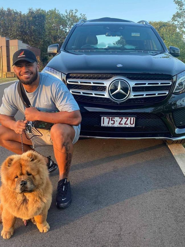 Payne Haas and his dog pose in front of his new car.