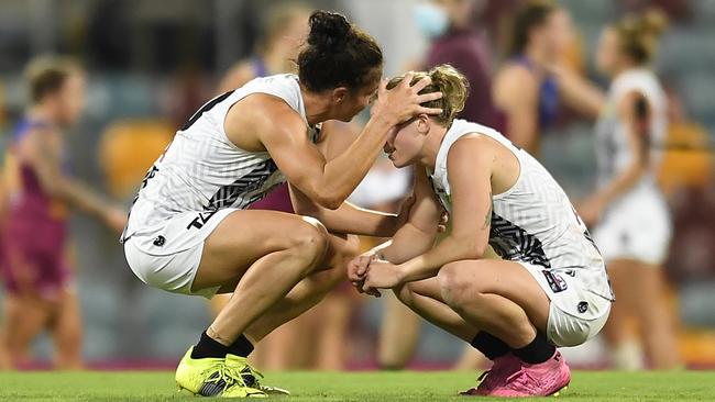 Ash Brazill consoles teammate Jaimee Lambert after the Pies’ heartbreaking defeat. Picture: Getty Images