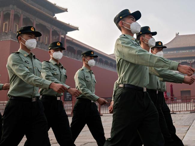 (FILES) In this file photo taken on May 21, 2020 People's Liberation Army (PLA) soldiers march next to the entrance to the Forbidden City during the opening ceremony of the Chinese People's Political Consultative Conference (CPPCC) in Beijing. - The Chinese military is pressing to double its 200-plus nuclear warheads within a decade with the ability to launch them aboard ballistic missiles by land, sea and air, the Pentagon said in a report September 1, 2020. (Photo by NICOLAS ASFOURI / AFP)