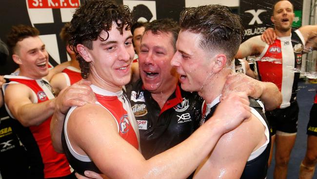 Nick Coffield and Doulton Langlands are joined in the middle of the circle by Brett Ratten after the win over the Bulldogs. Pic: Getty Images