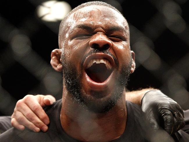 Jon Jones yells out after defeating Daniel Comier in his last light-heavyweight title fight.