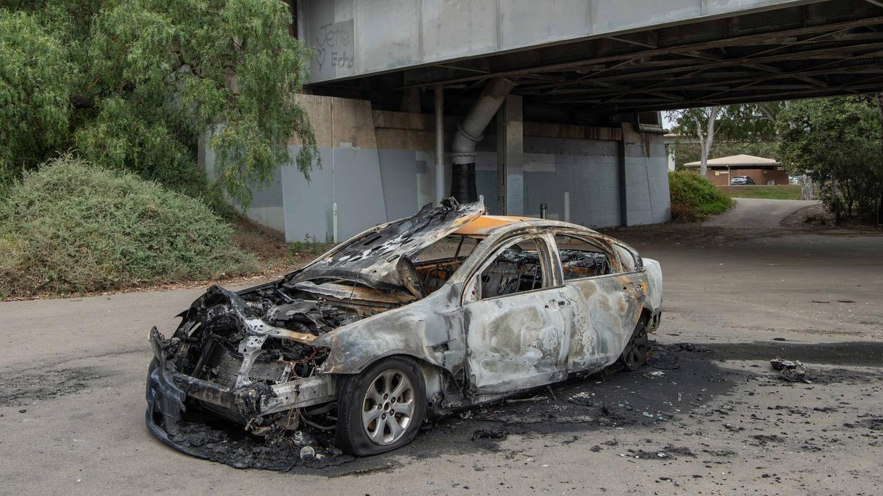 Burnt out car under a bridge. Picture: Brad Fleet