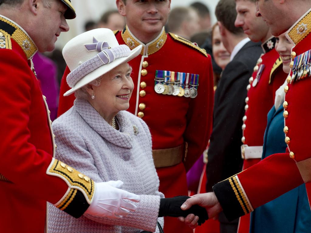 Queen Elizabeth II (C) meets soldiers and their families during a reception at Victoria Baracks in 2012. Picture: AFP