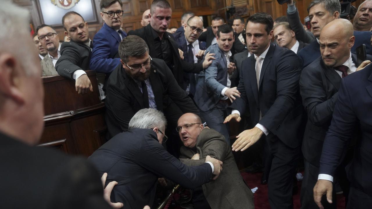 Ruling party lawmakers, opposition members, and some ministers fight during Monday’s parliament session. Picture: AP